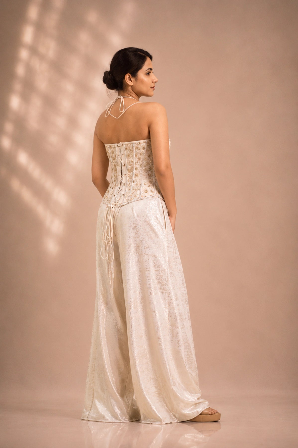 Ivory net corset co-ord set, back view showing lace-up corset detail, occasion wear by Label Neha Sinha
