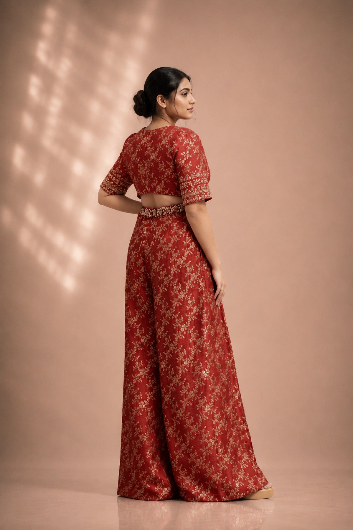 Red silk brocade jumpsuit, back view showing open cutout back and zardosi embroidered waistband, occasion wear by Label Neha Sinha