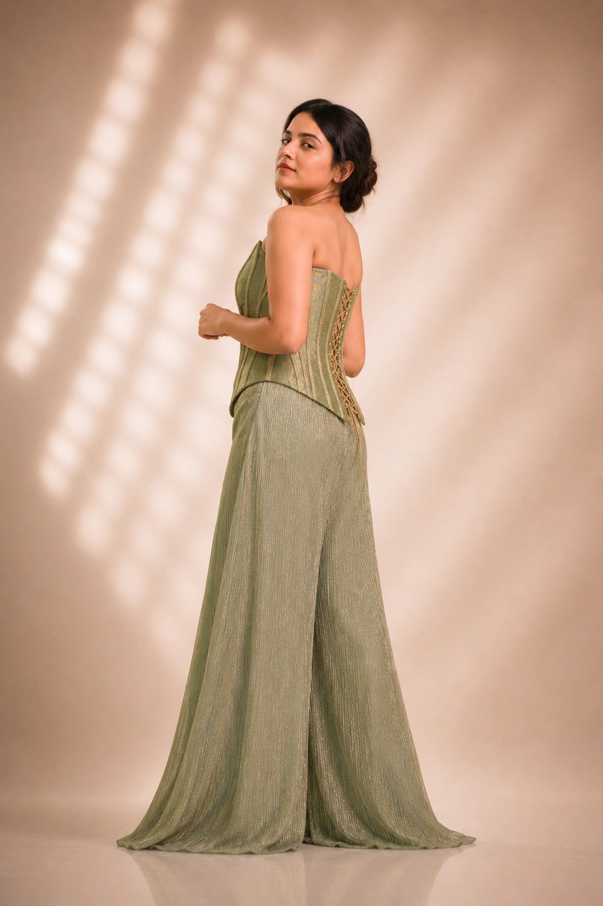 Sage green brocade corset co-ord set, back view showing lace-up corset detail and shimmer palazzo train, occasion wear by Label Neha Sinha