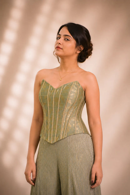 Close-up of sage green brocade corset bodice with gold piping detail, occasion wear by Label Neha Sinha